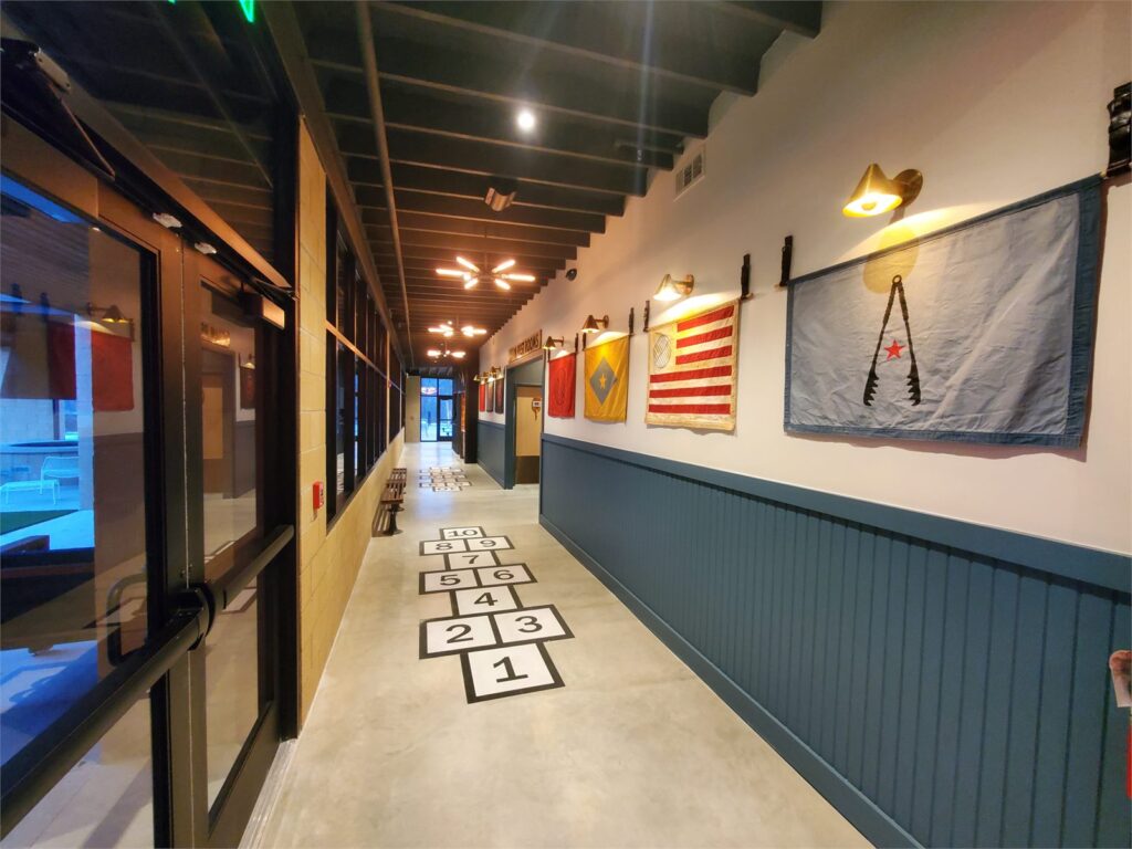Interior corridor with hopscotch floor graphics at Char Bar Parkville
